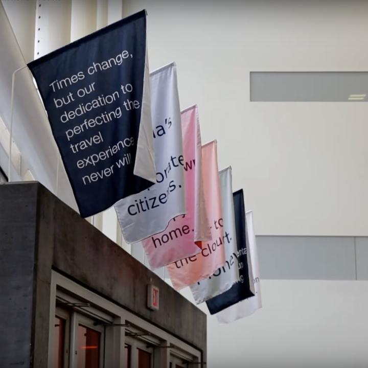 Colourful flags with text hung in OCAD U's main entrance