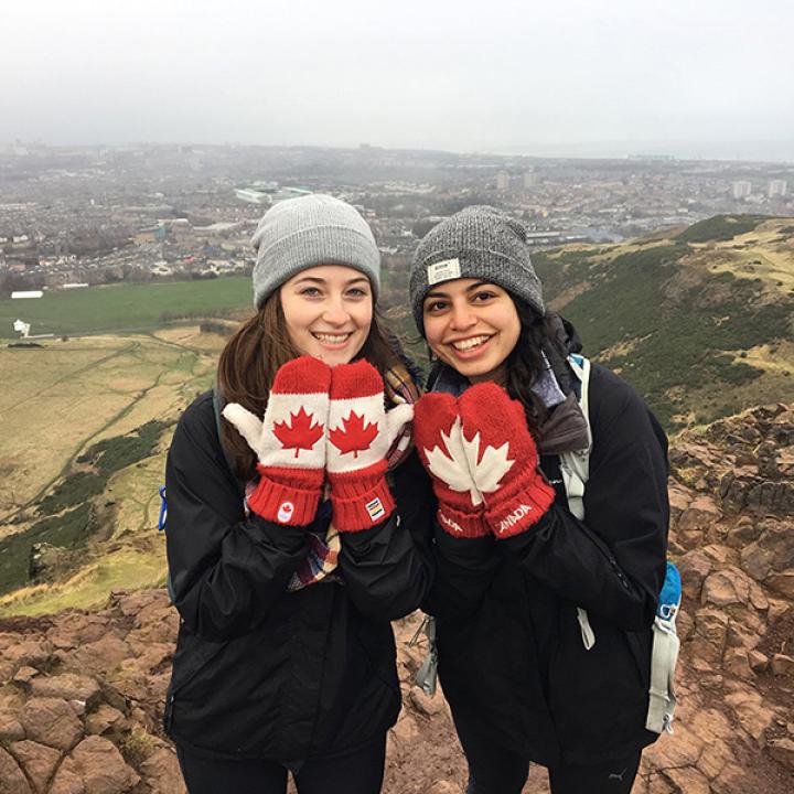 Two students showing off their canadian flag mittens