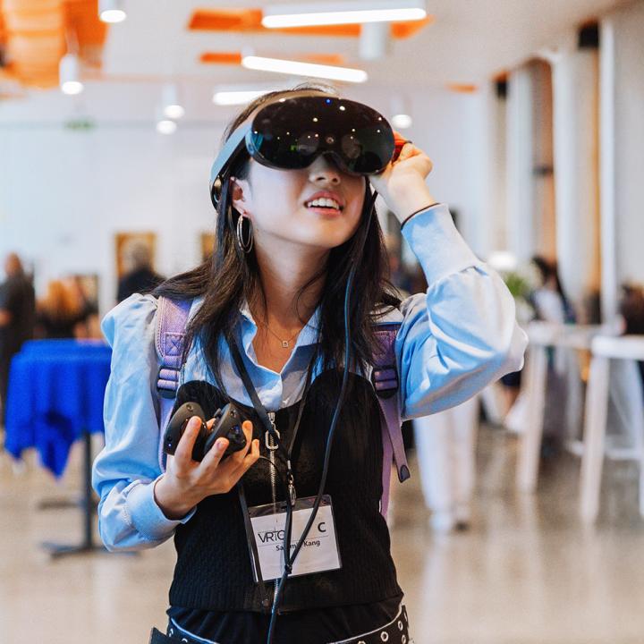 Person wearing a VR headset in a seminar room
